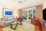 Bright and inviting living room with comfy seating, stylish decor, and garden views.