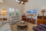 Plush seating at the living area with a large flatscreen TV.