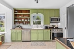 The spacious kitchen features stainless steel appliances, a gas stove, and plenty of prep space for your culinary needs.