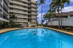 Community pool with BBQs and lounge seating