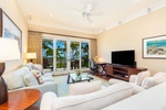 Bright and cozy living room with plush seating and views through the sliding doors.