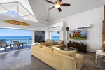 Spacious great room opens to the lanai with vaulted ceilings and wall-to-wall ocean views.