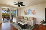 Living room with access to the private lanai and tropical views.