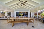 Spacious lanai with fans and seating, perfect for island-style dinners.