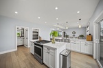 Cook and connect in the gourmet kitchen with a large island, gas range, and space for everyone to gather.