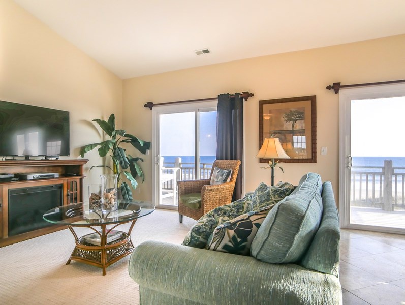The living area with a Smart TV and access to the oceanfront deck