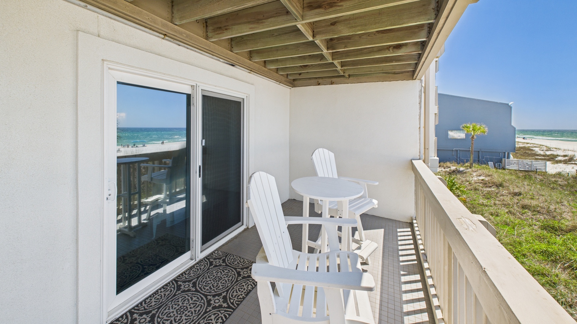 Huge balcony with seating and tables with coastal views