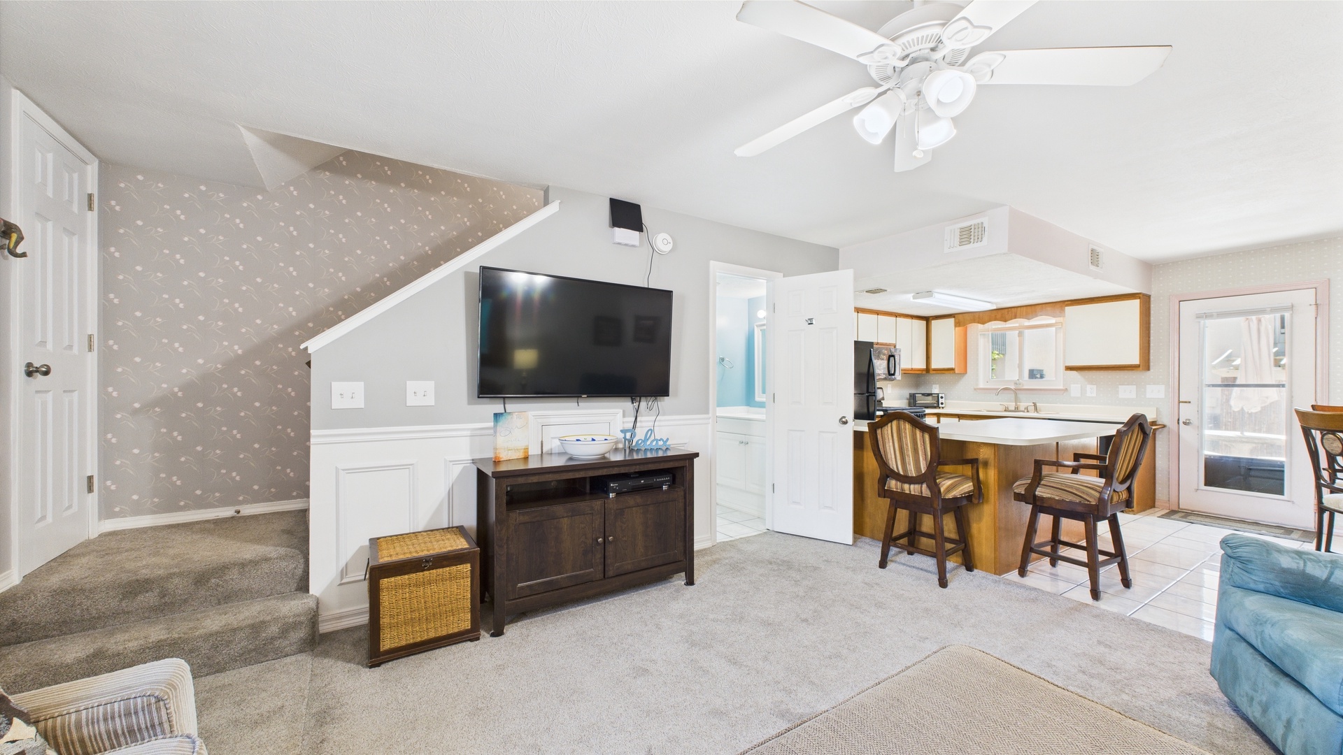 Open concept living area with TV and sleeper sofa
