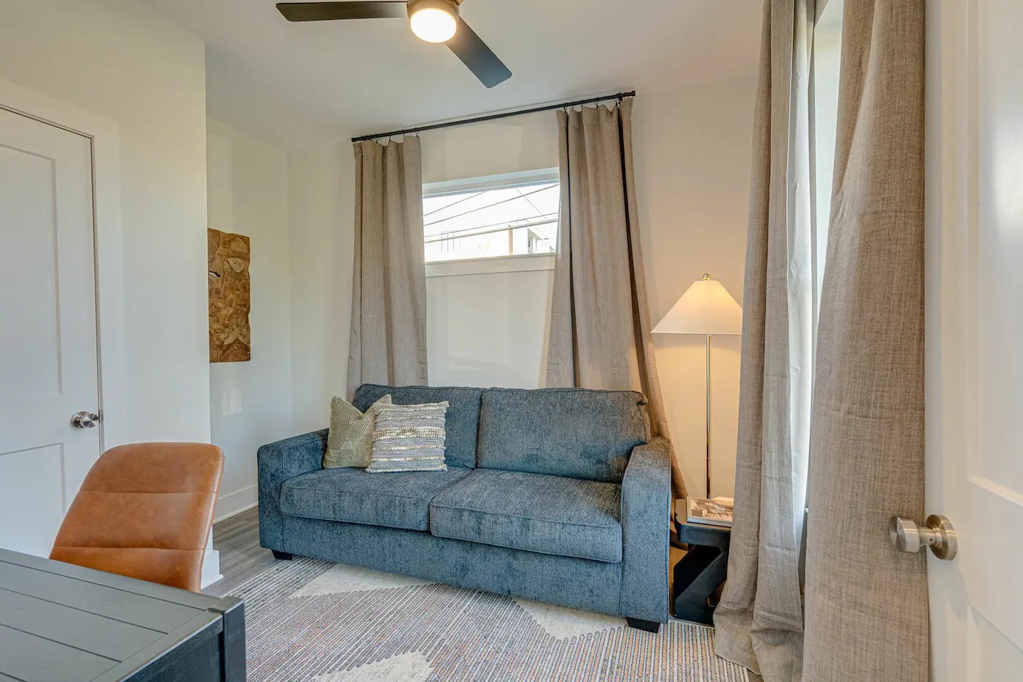 5631 - 3rd Bedroom / Office featuring a pull-out couch and workstation.