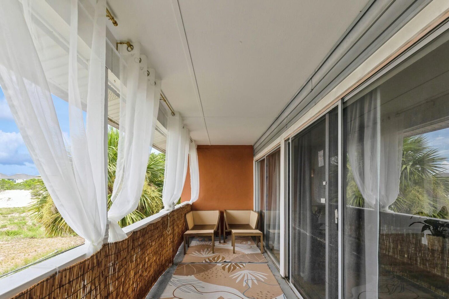 Private balcony with seating and blinds