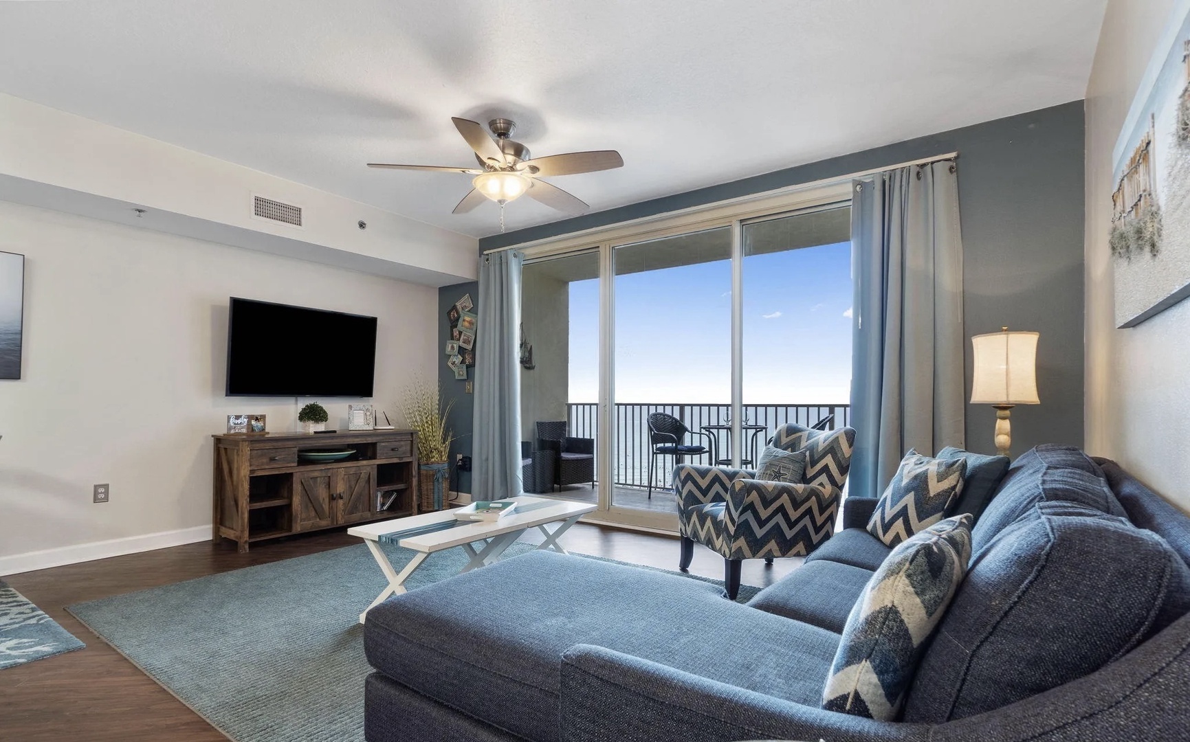 Open concept living area with stylish furnishings, TV, and scenic views. Features a queen size pullout sofa as well.