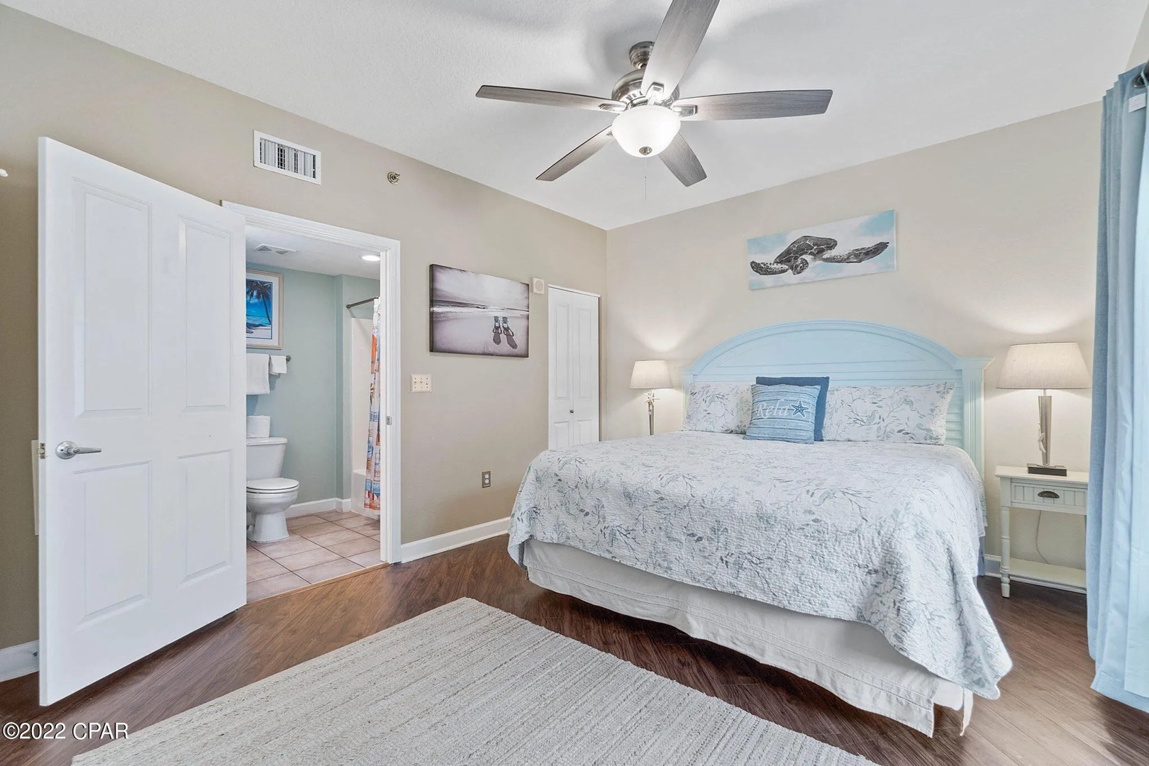 Primary bedroom with king bed, TV, and scenic views. Features an ensuite bathroom.