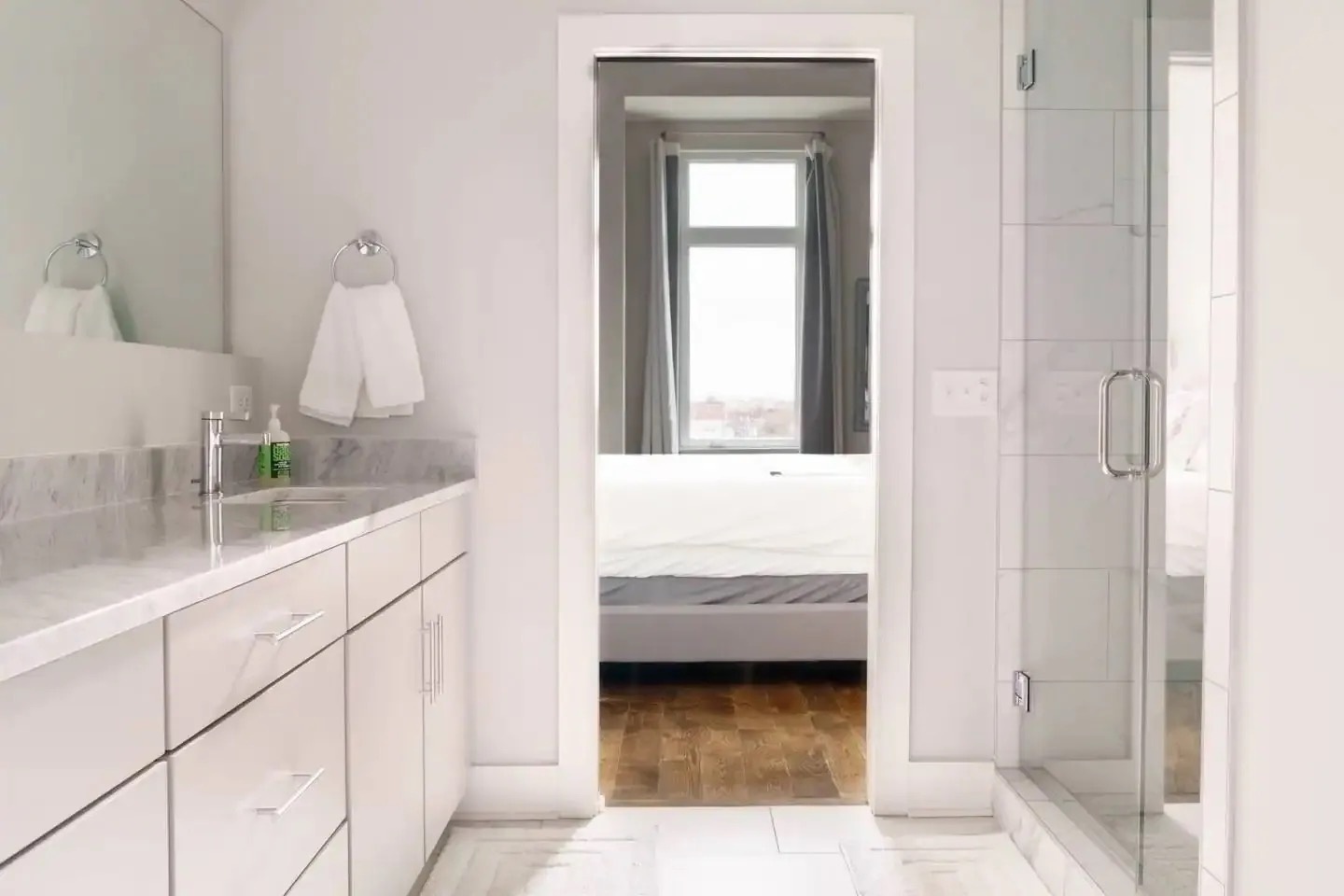 Primary bathroom with dual vanity walk in shower and master closet