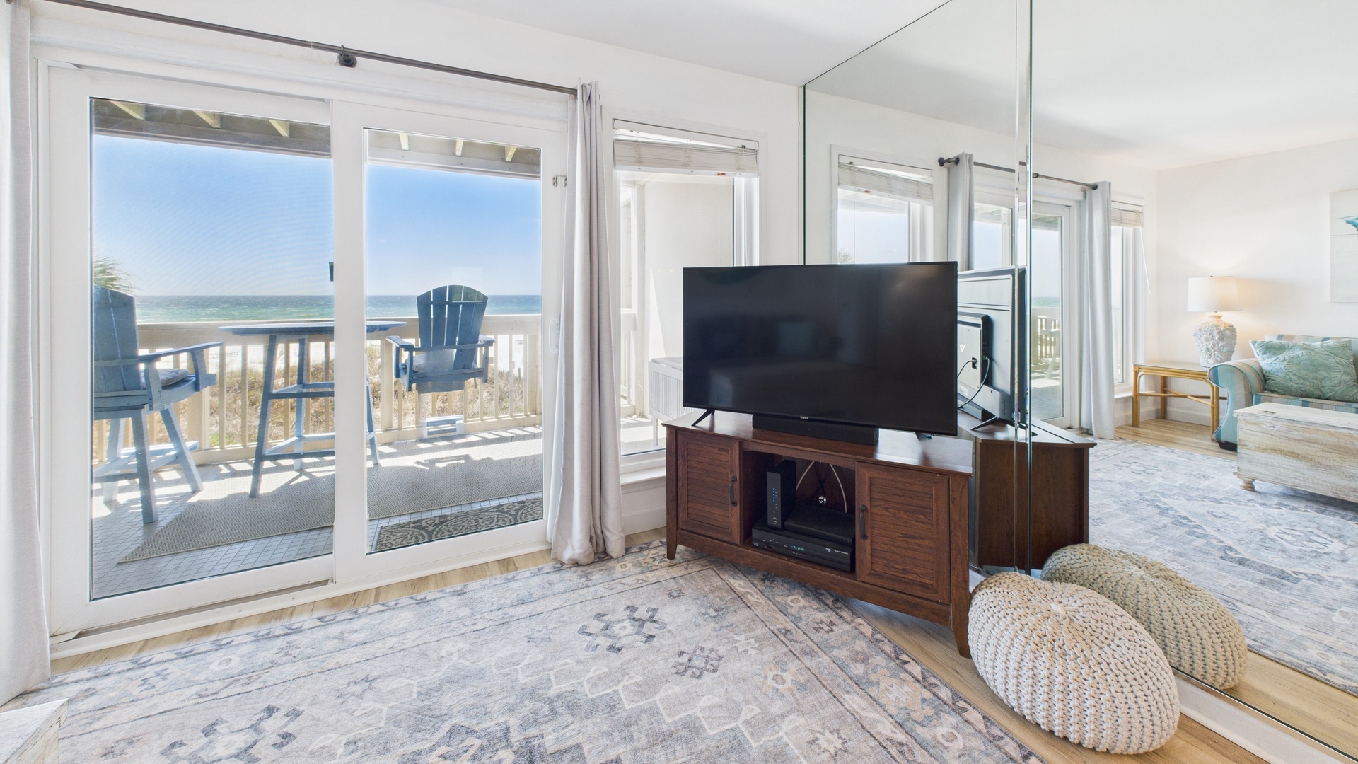 Open concept living area with stylish furnishings sleeper sofa TV and balcony access