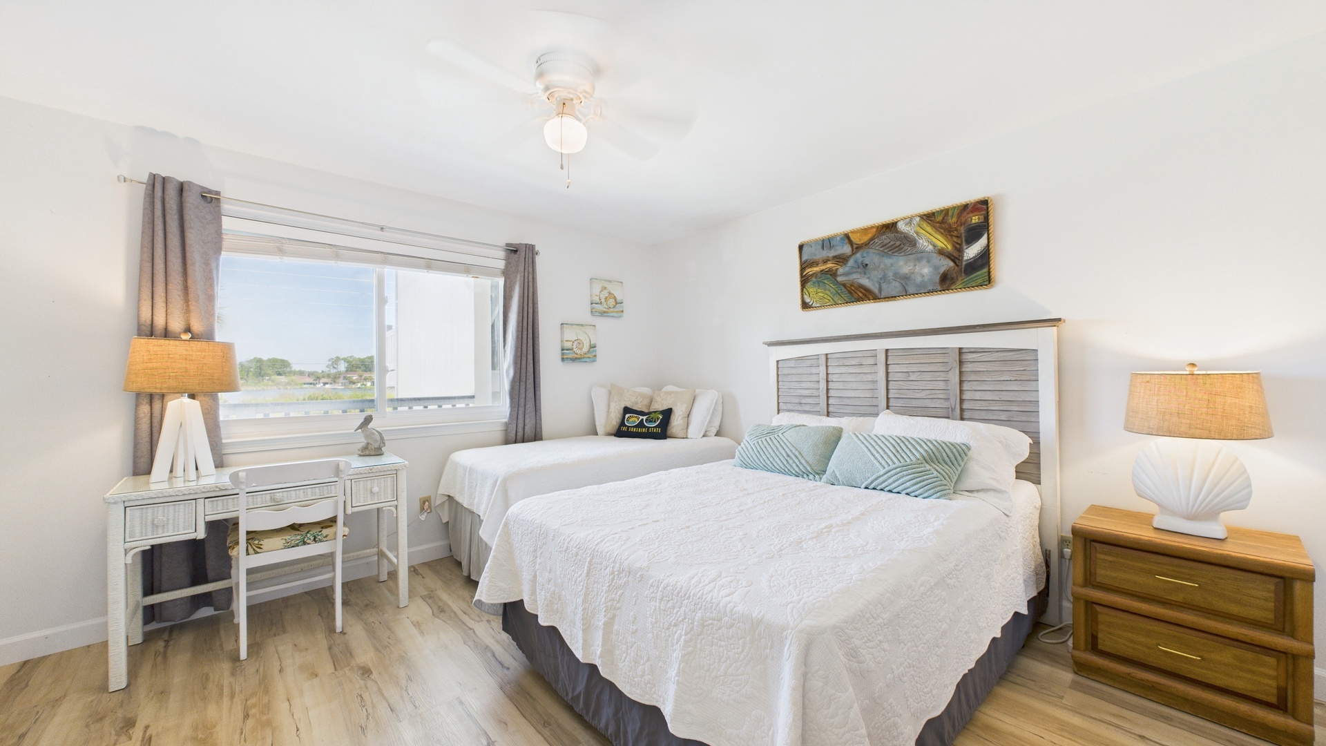 Guest bedroom with twin and queen beds TV and desk