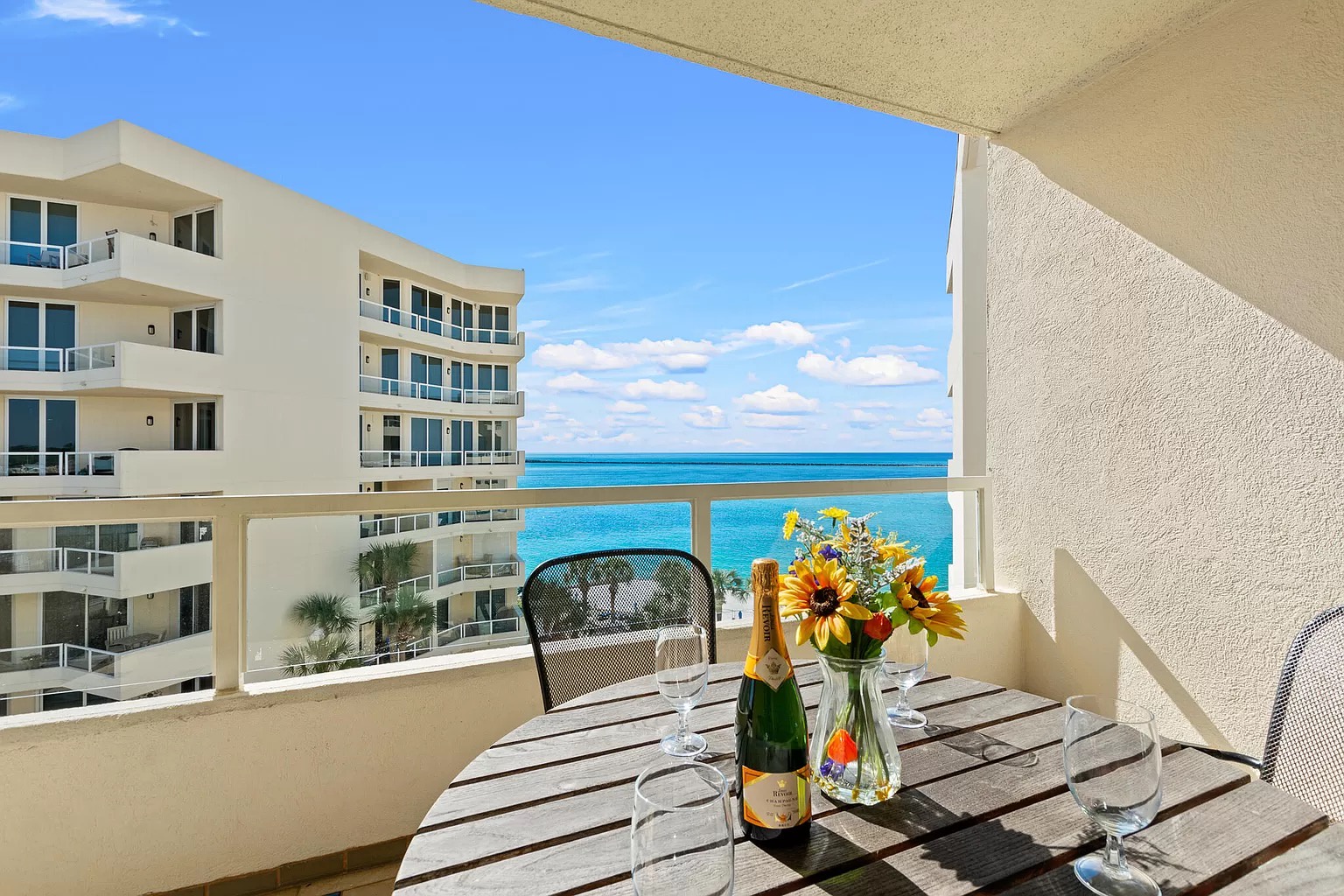 Dining table outside on balcony with seating for four