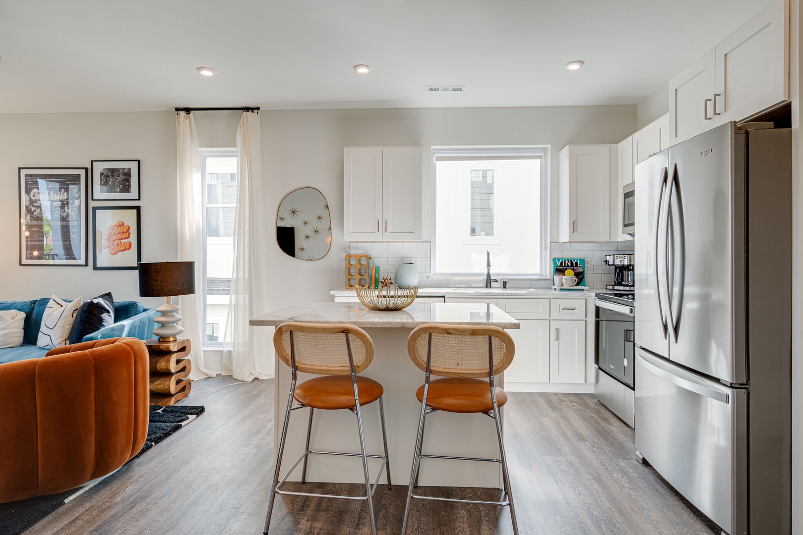 Bright and open kitchen equipped with stainless steel appliances and is fully stocked with your basic cooking essentials. Features breakfast bar seating and connects to living space.