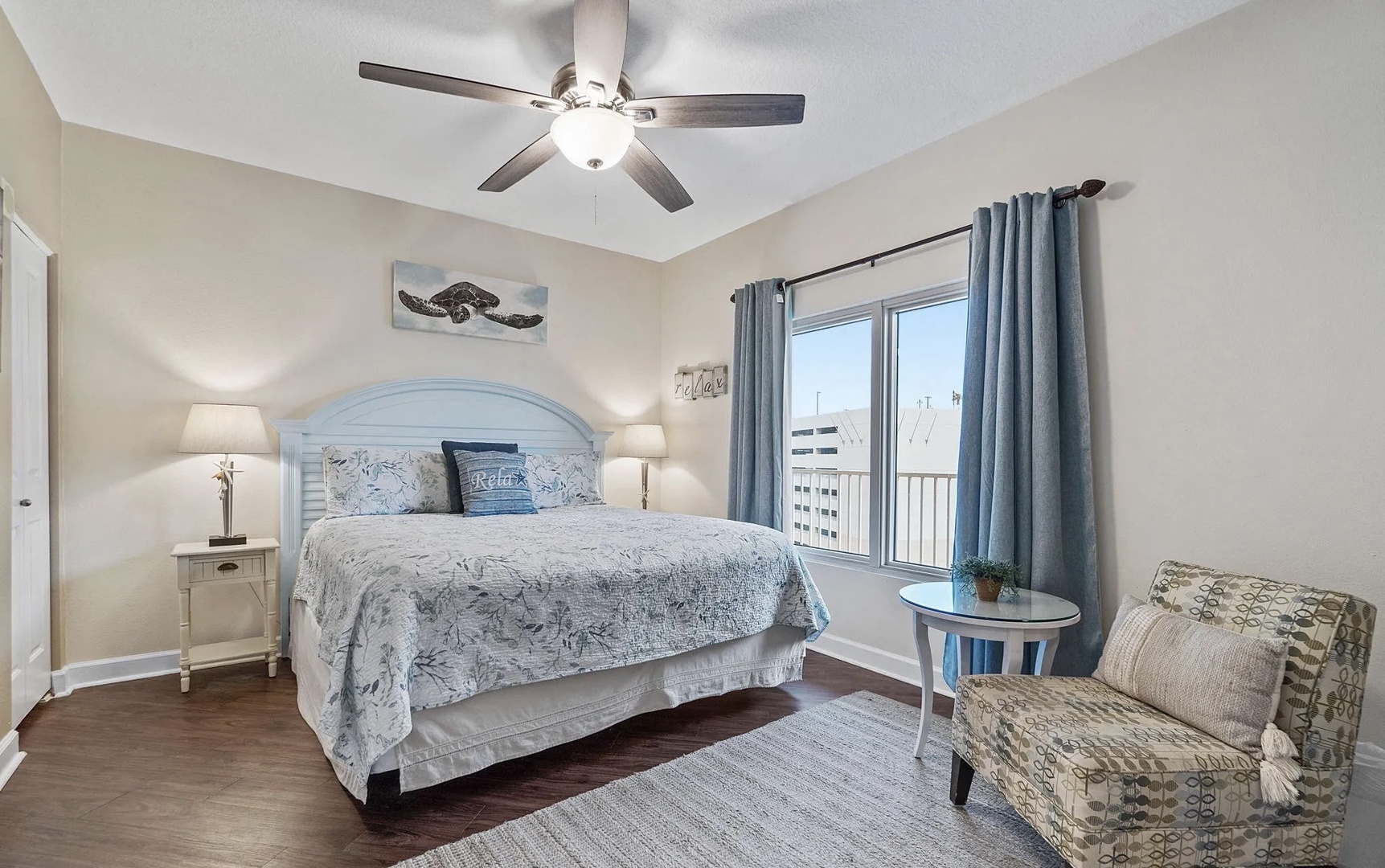 Primary bedroom with king bed, TV, and scenic views. Features an ensuite bathroom.