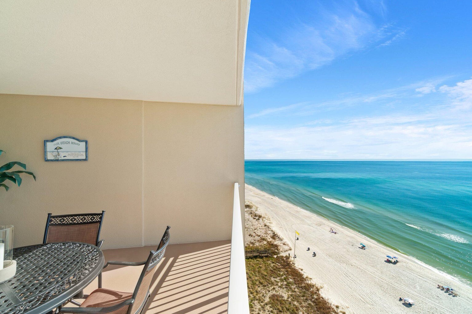 Balcony with dining table and coastal views