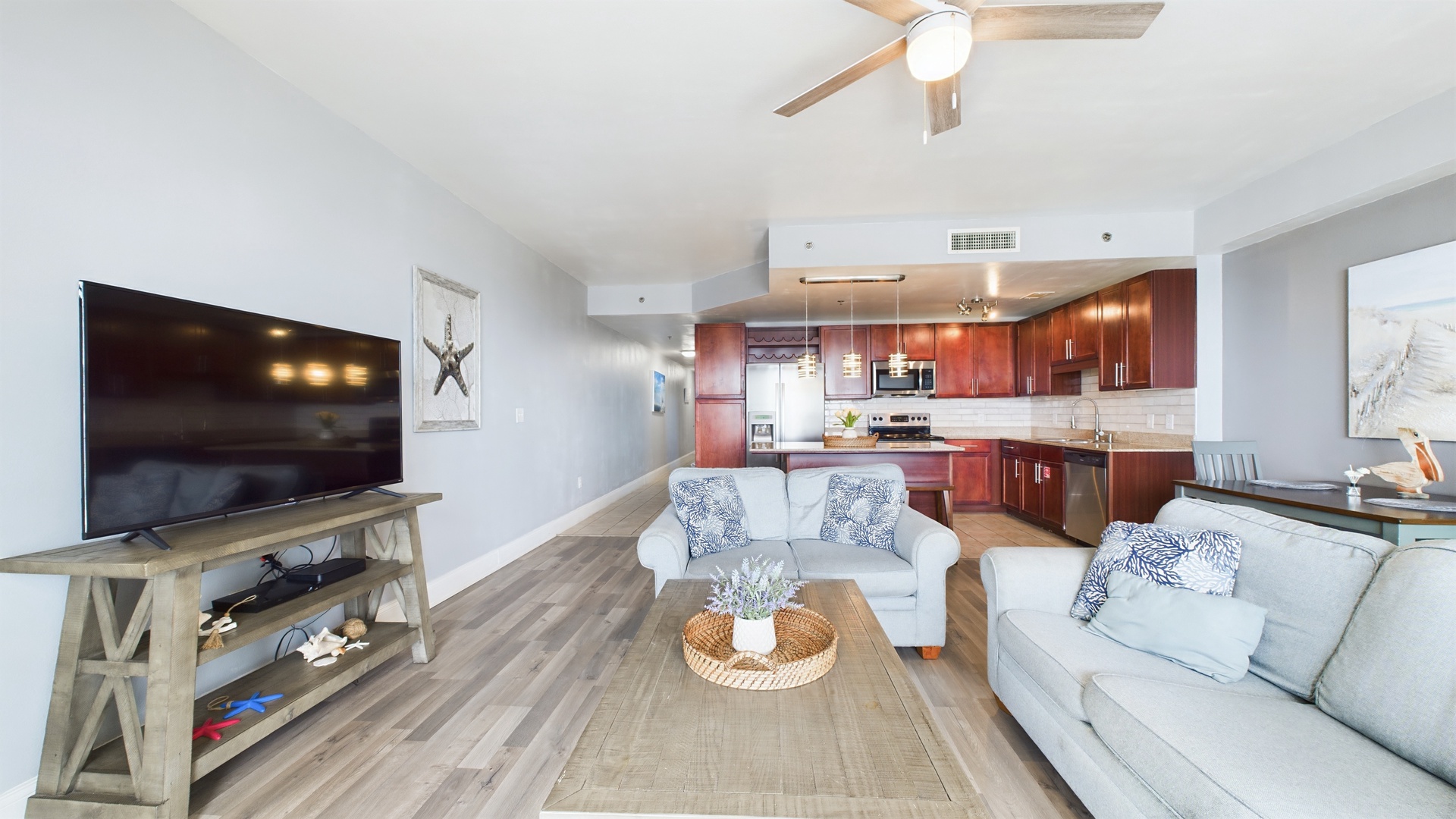 Open concept living area with TV coastal views and sleeper sofa