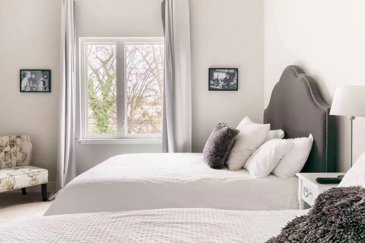 Guest bedroom with 2 queen beds TV and ensuite bathroom