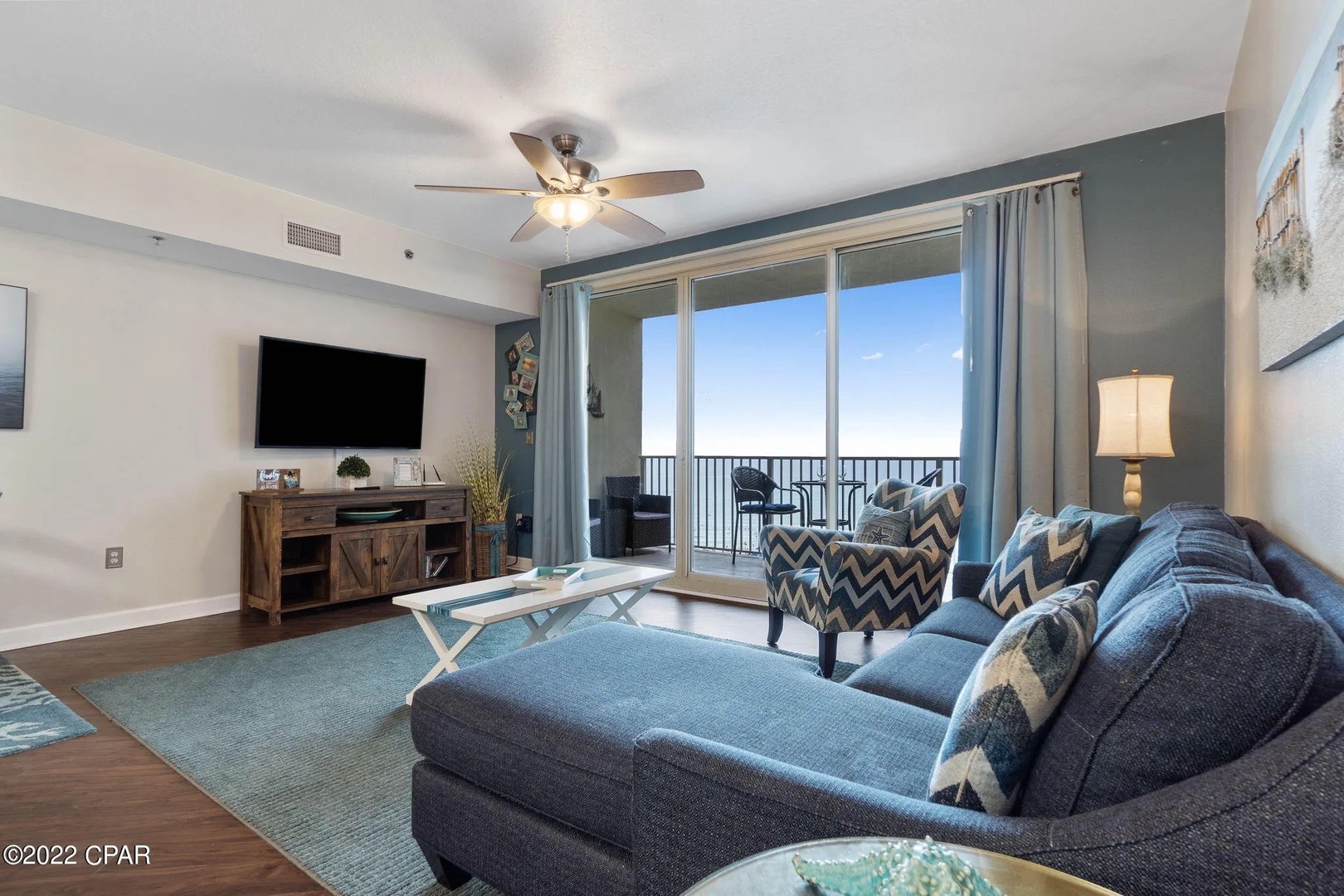 Open concept living area with stylish furnishings, TV, and scenic views. Features a queen size pullout sofa as well.