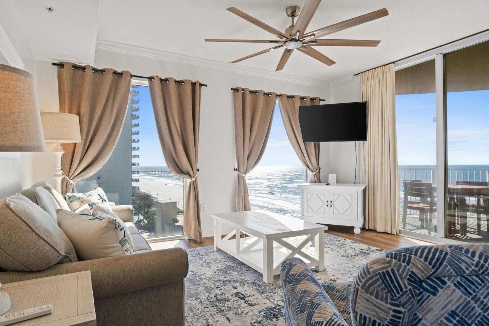 Open concept living area with sleeper sofa TV and balcony access