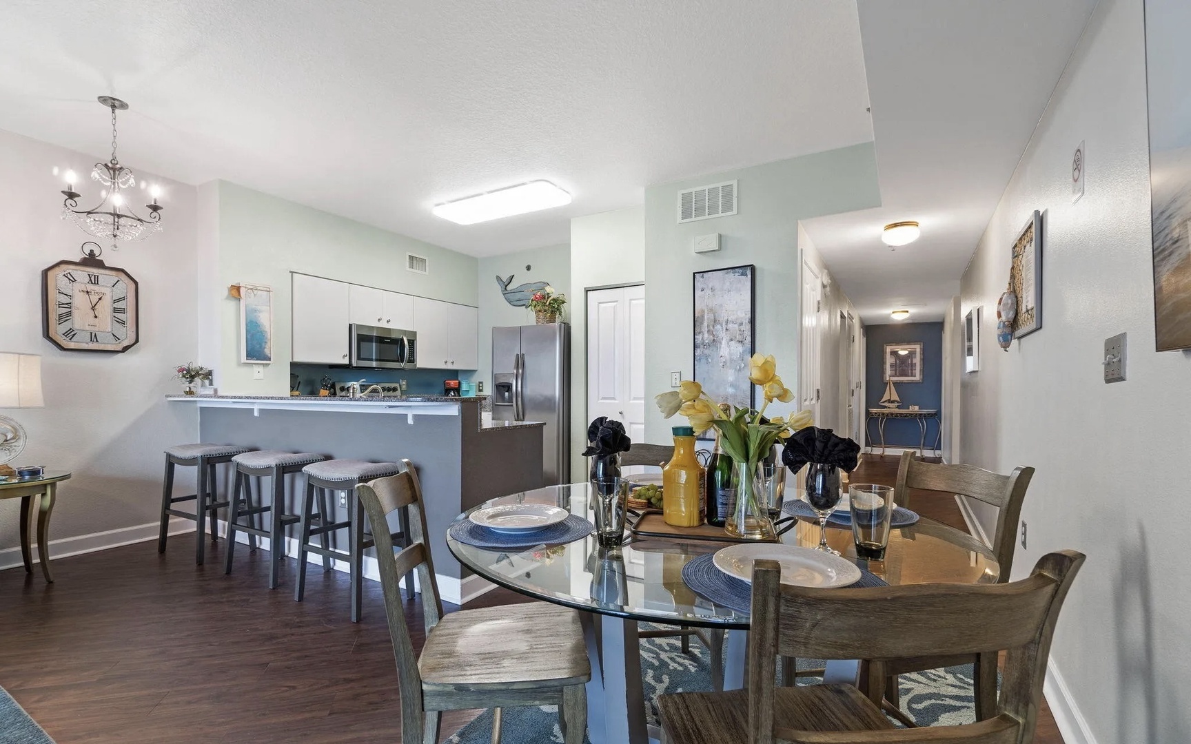 Dining area with table that seats 4 and breakfast bar seating 3.