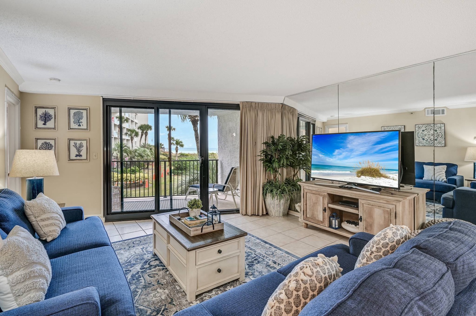 Open concept living area with TV balcony access and sleeper sofa