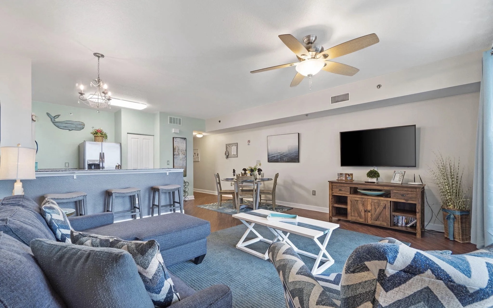 Open concept living area with stylish furnishings, TV, and scenic views. Features a queen size pullout sofa as well.