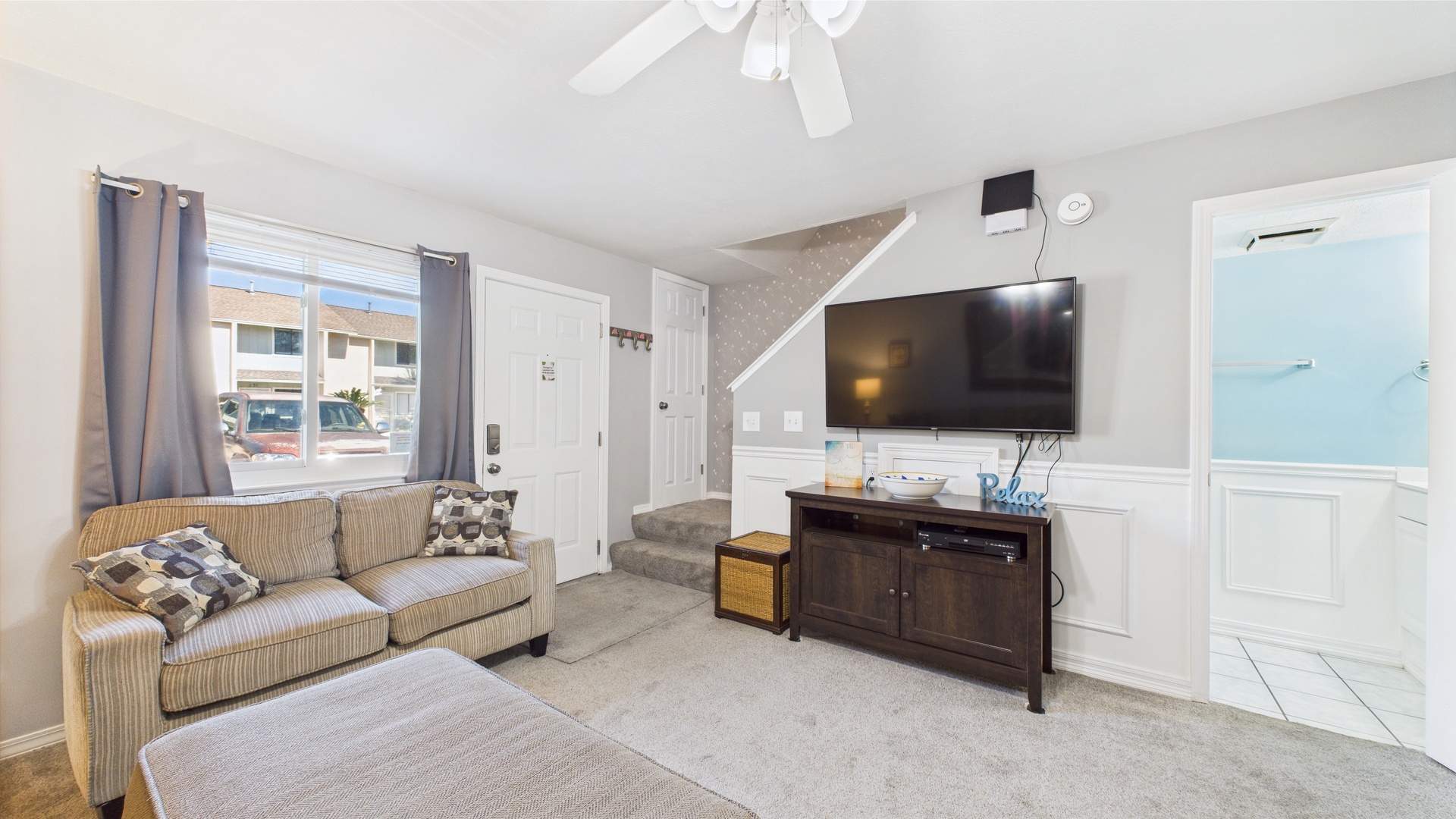 Open concept living area with TV and sleeper sofa
