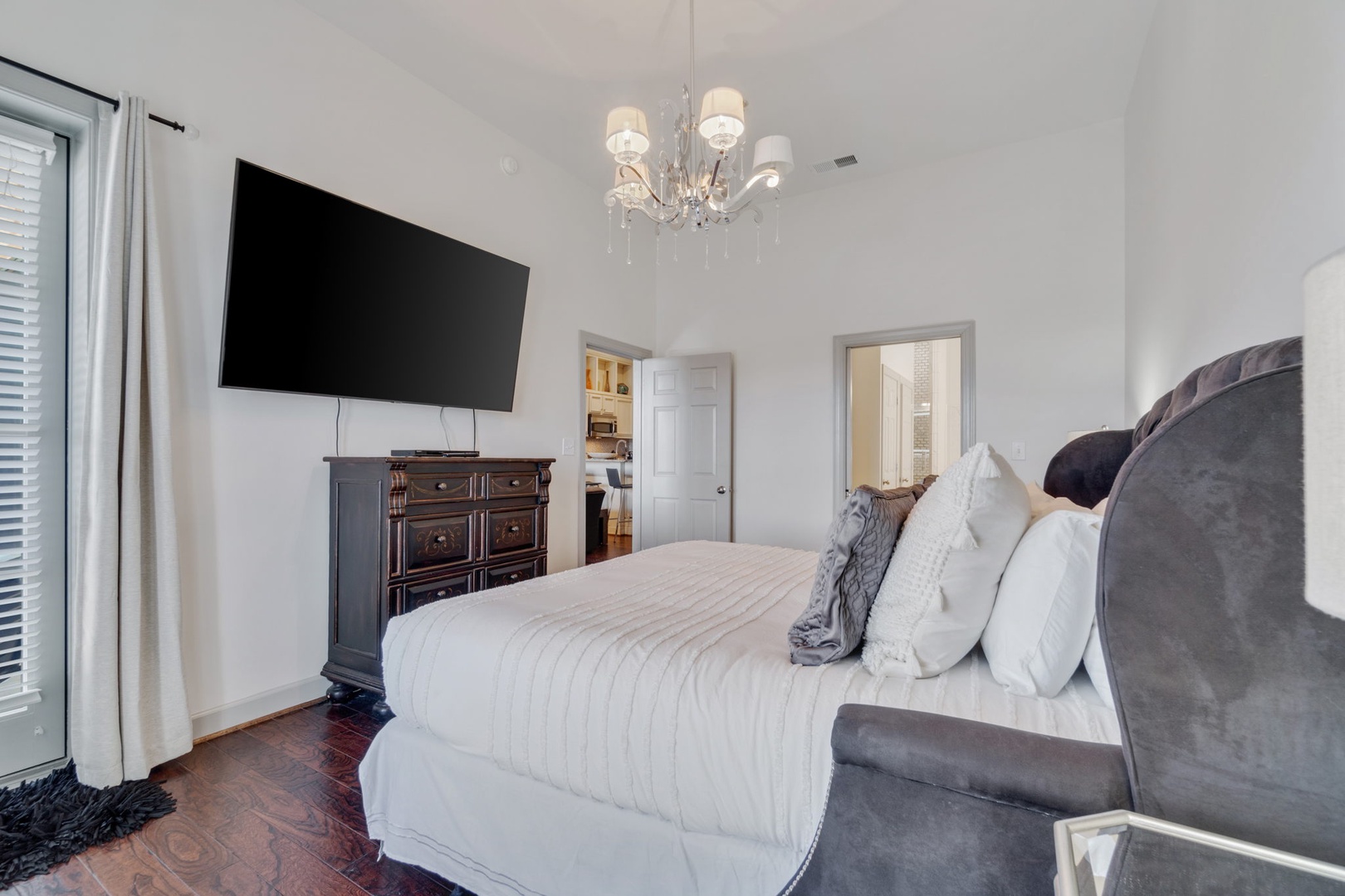 Master bedroom with king size bed and tv screen
