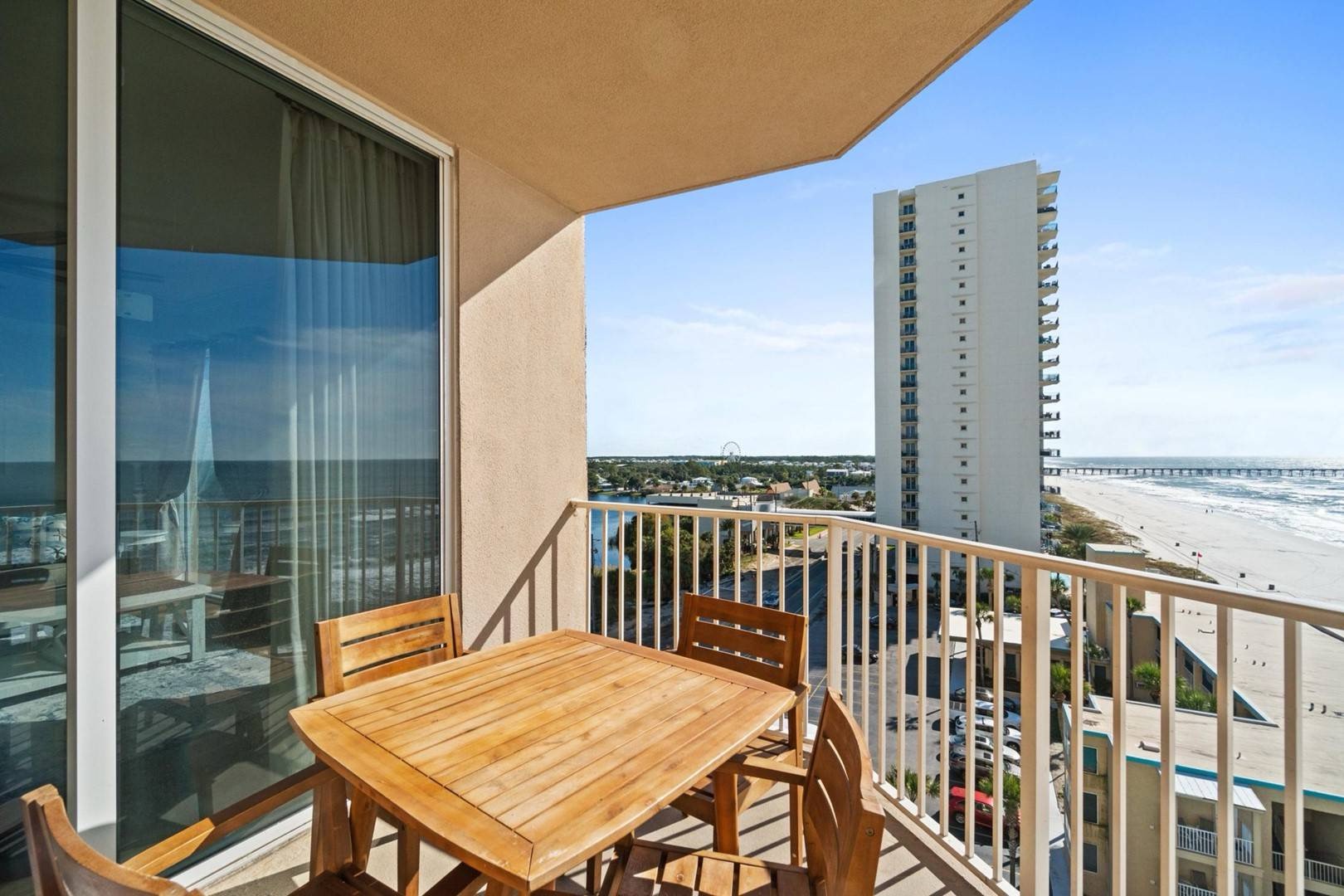 Balcony with dining table and coastal views