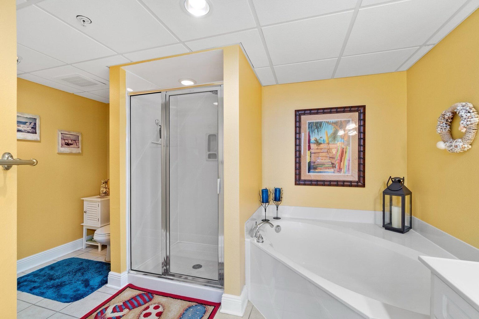 Primary bathroom with dual vanity bathtub and walk in shower