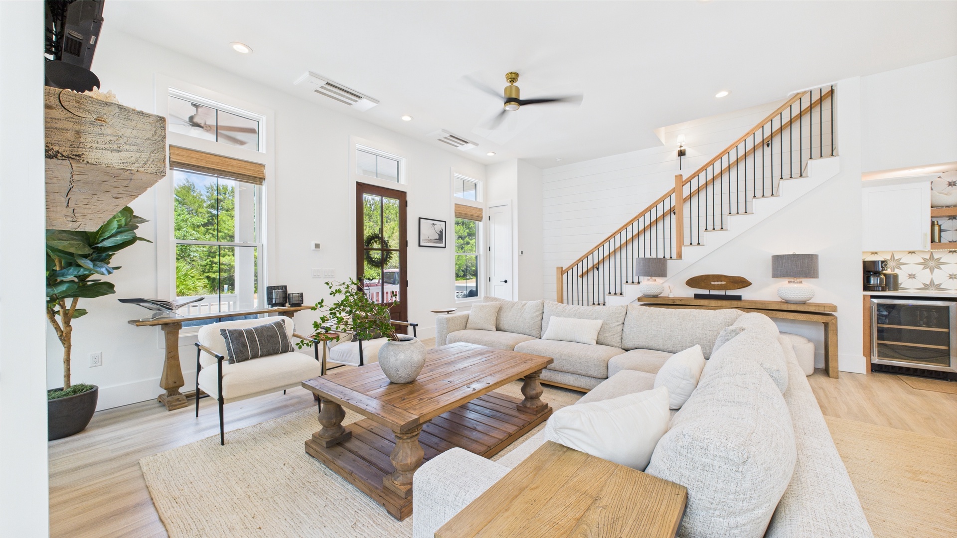 Open concept living area with stylish furnishings and huge TV