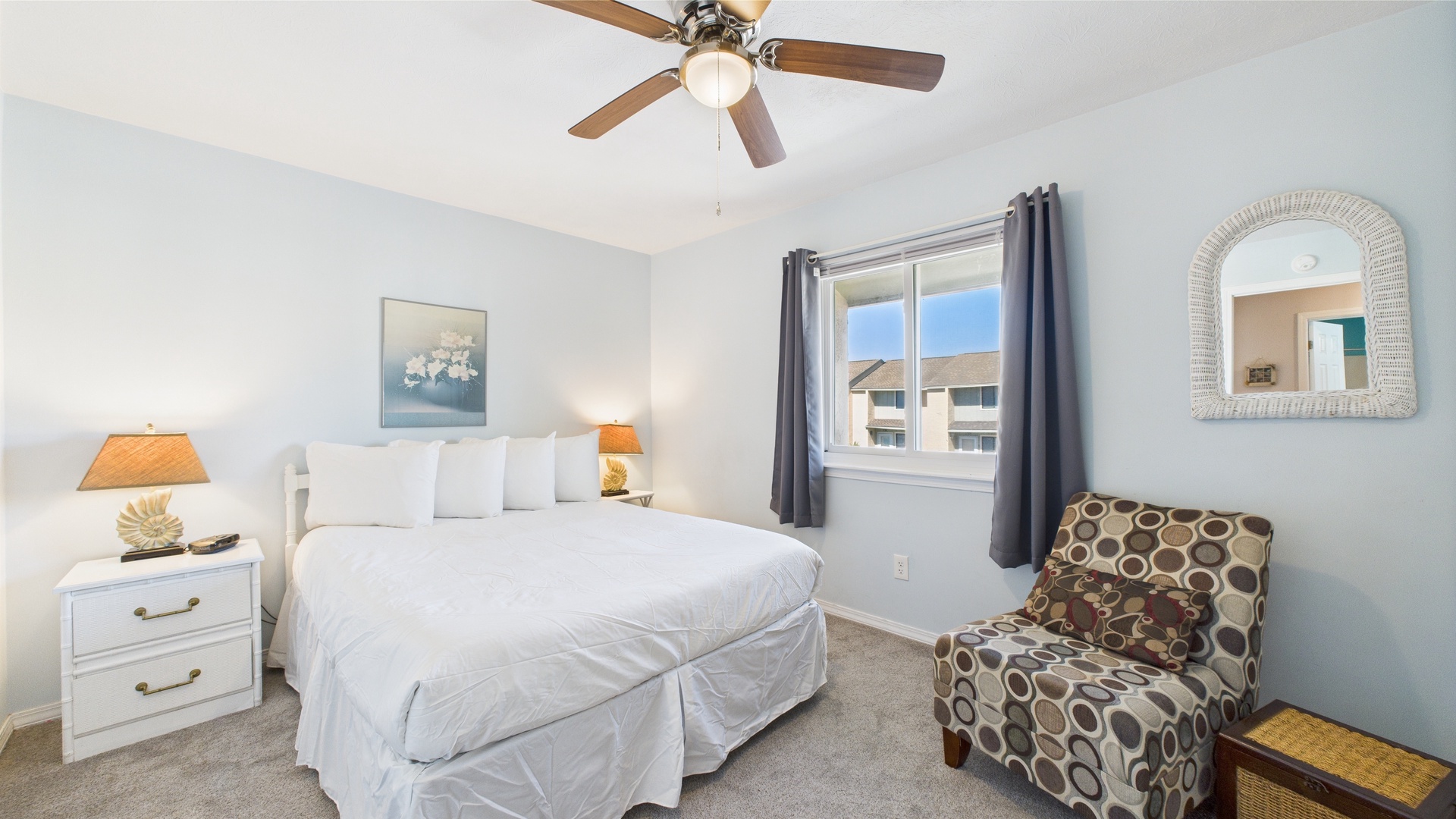 Guest bedroom with queen bed and TV