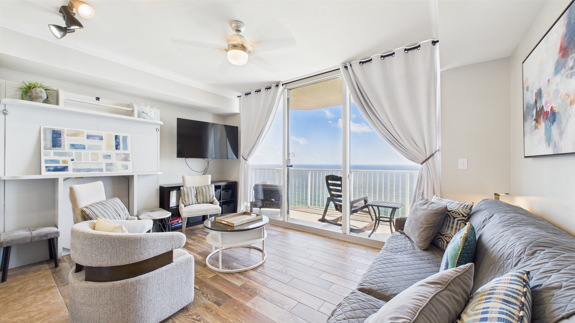 Open concept living area with stylish furnishings TV and sleeper sofa