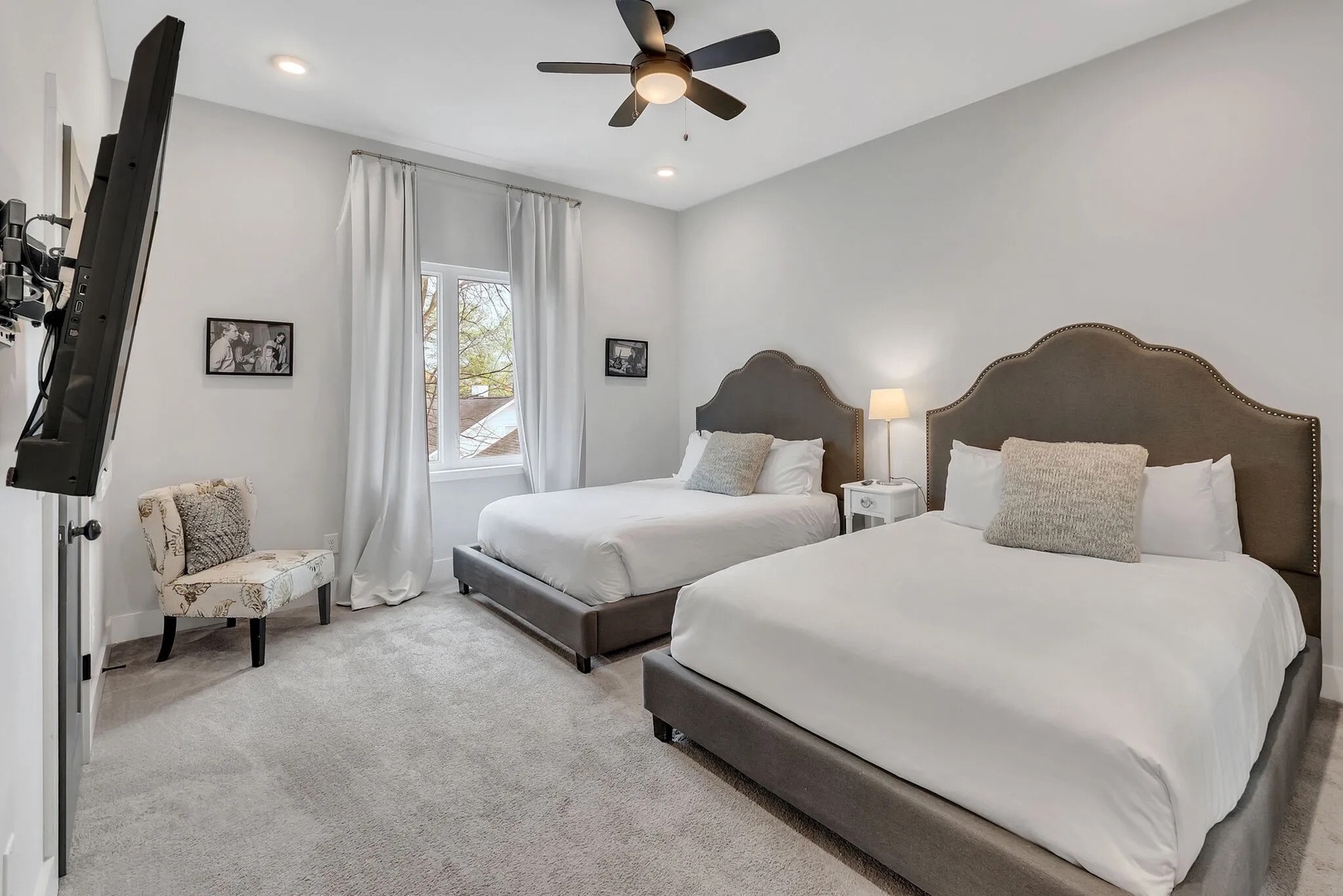 Guest bedroom with 2 queen beds TV and ensuite bathroom