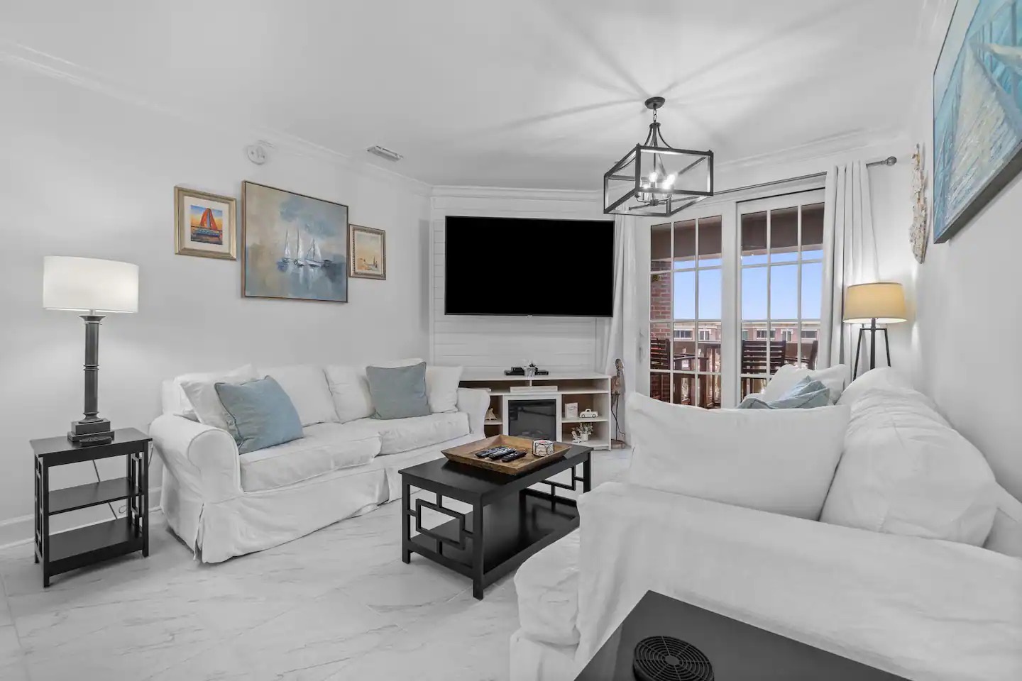 Open concept living area with stylish furnishings balcony access and sofa bed