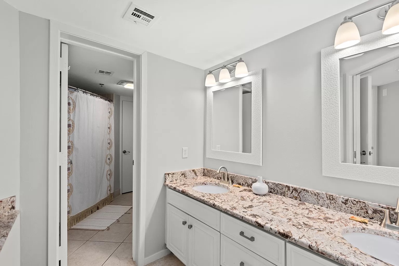 Master bedroom ensuite bathroom with double vanity and shower/tub combo