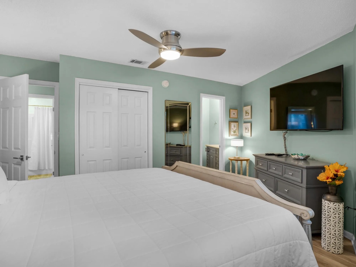 Primary bedroom with king bed, TV, and ensuite bathroom.