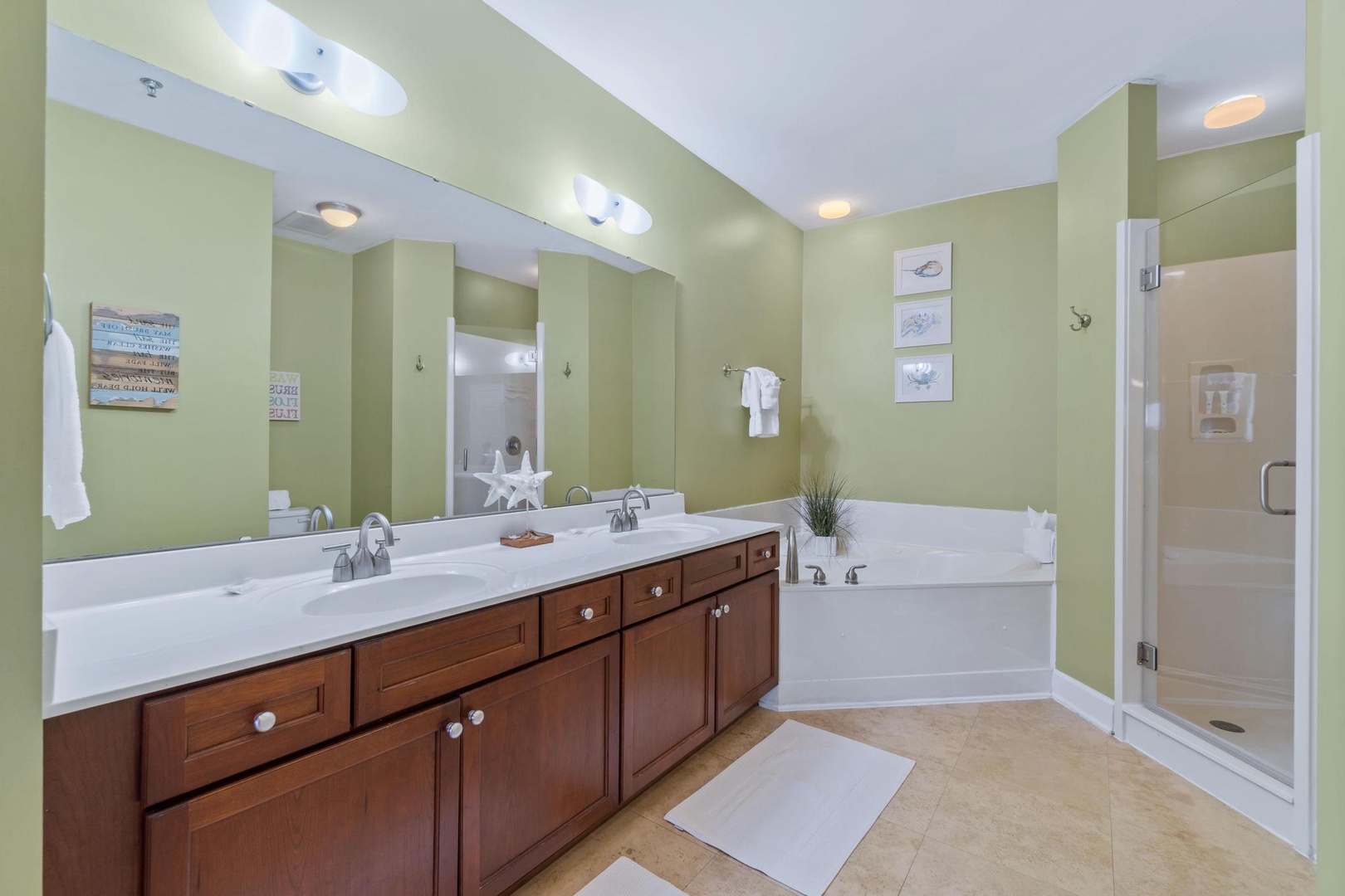 The large master bath has a double sink, over-sized shower, and a jetted jacuzzi tub
