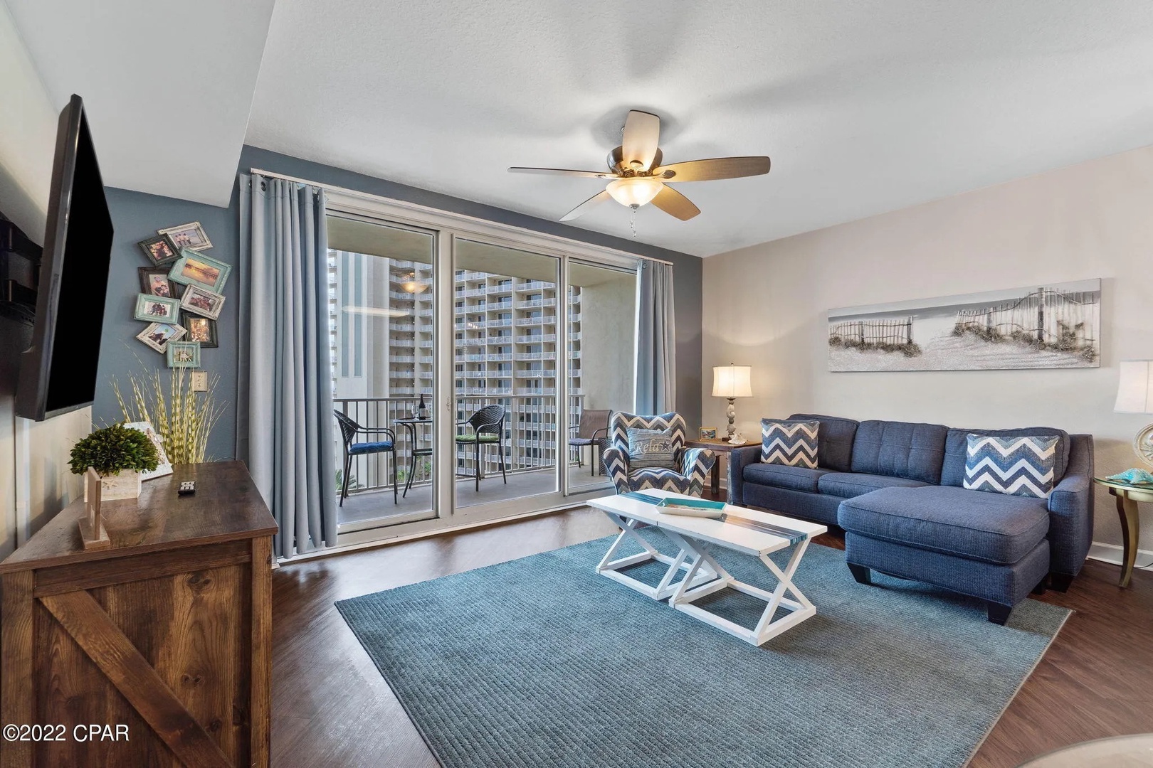 Open concept living area with stylish furnishings, TV, and scenic views. Features a queen size pullout sofa as well.