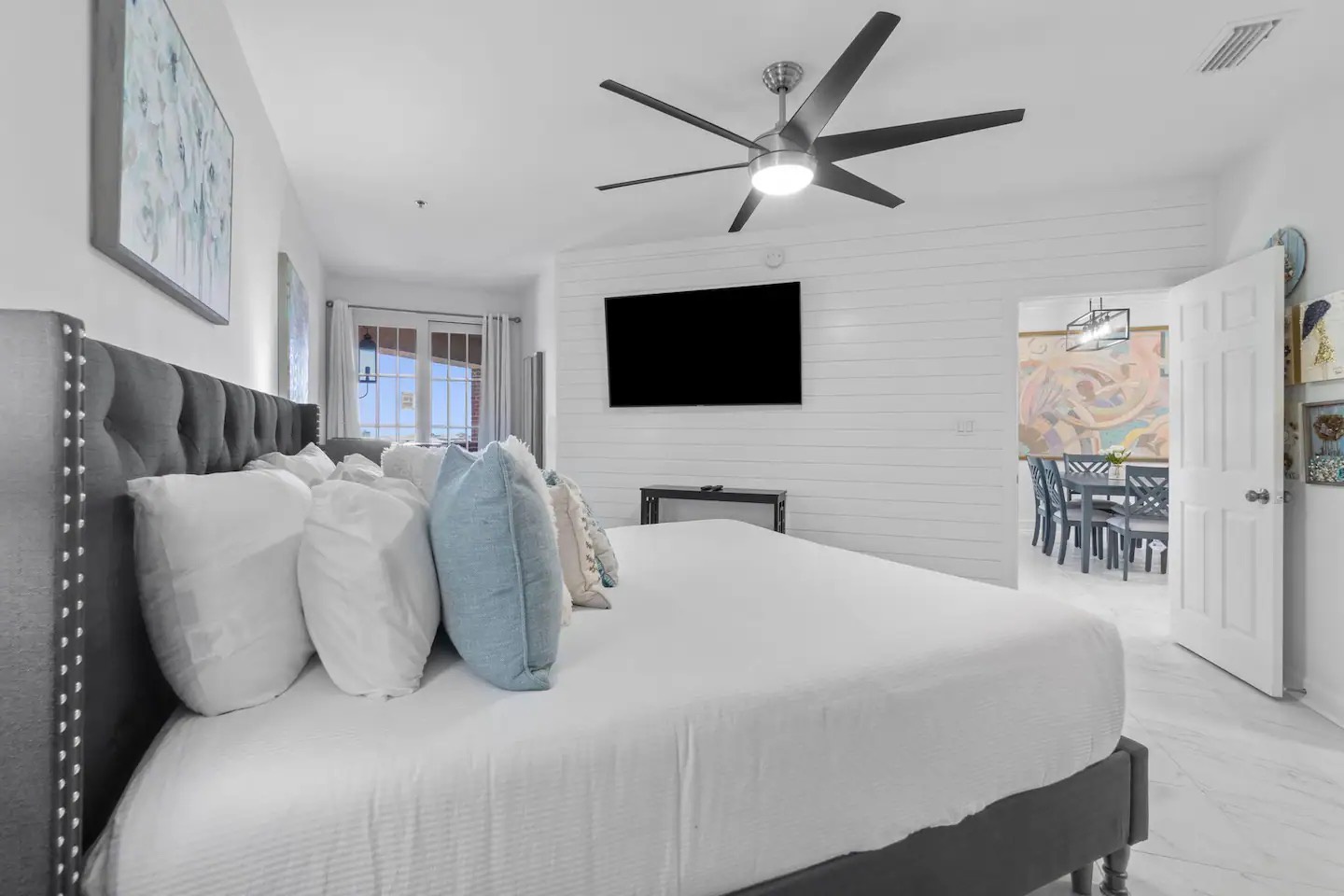 Primary bedroom with king bed desk and ensuite bathroom