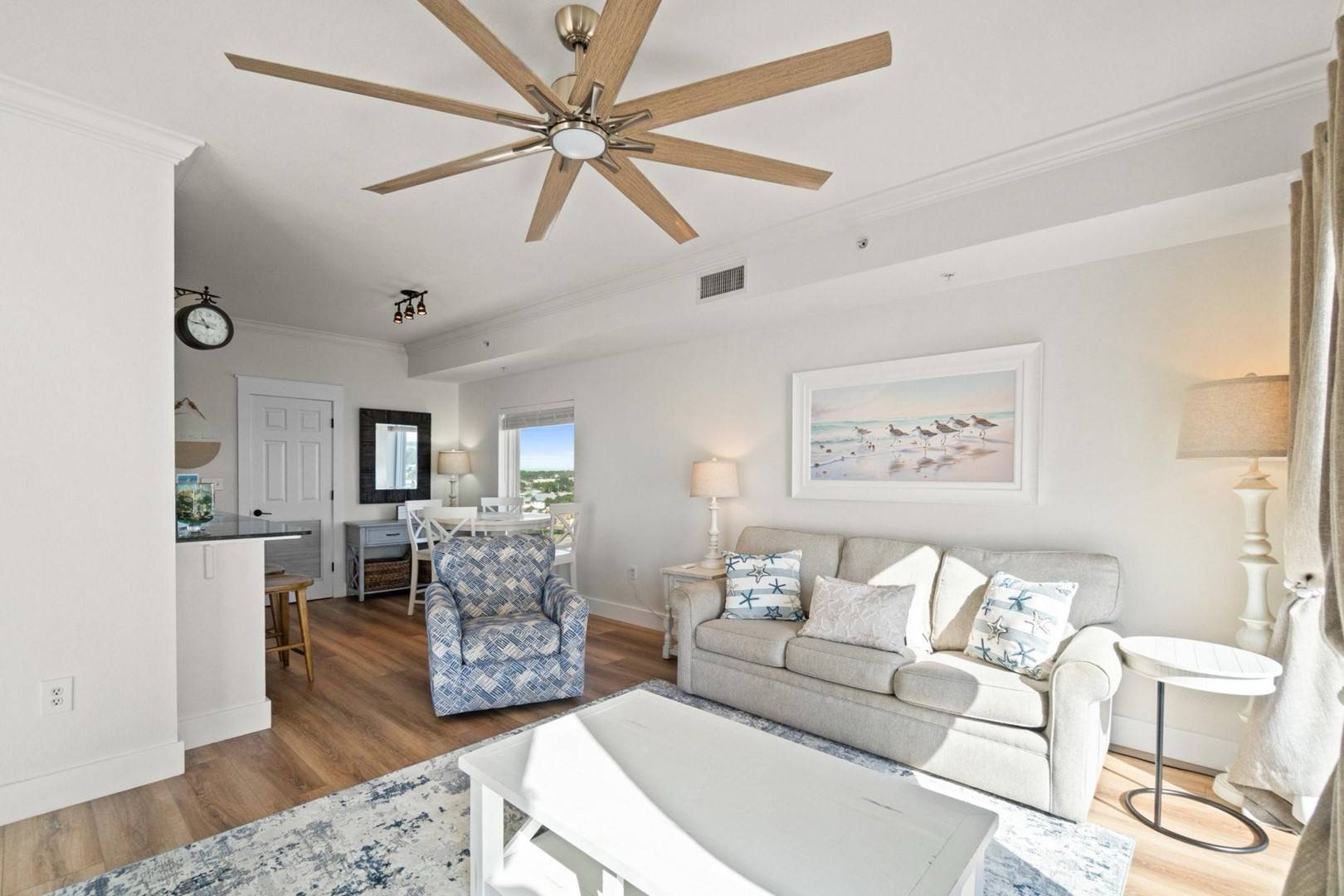 Open concept living area with sleeper sofa TV and balcony access
