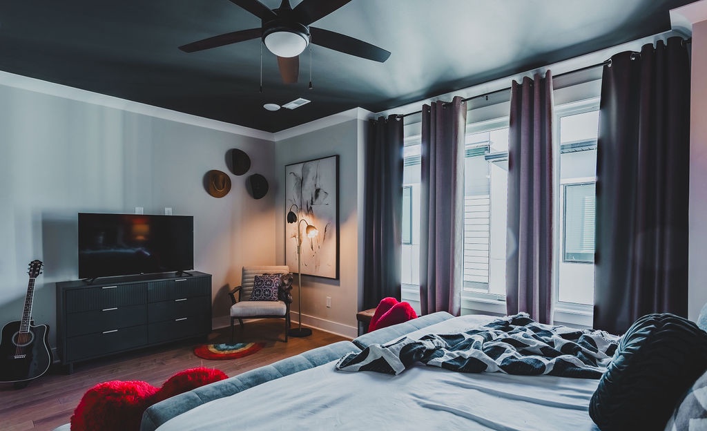 Primary bedroom with king bed TV and ensuite bathroom