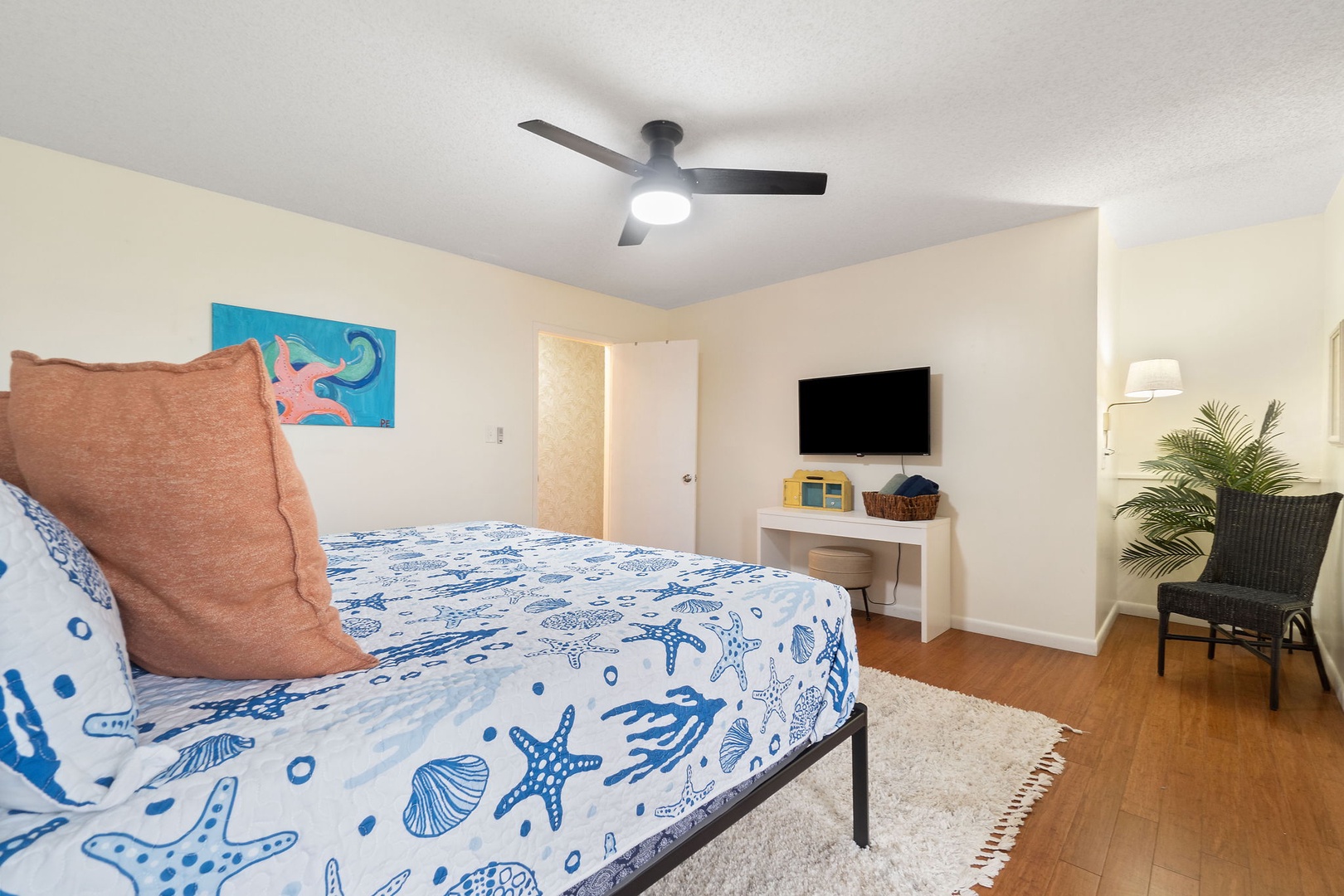 Primary bedroom with king bed TV and balcony access