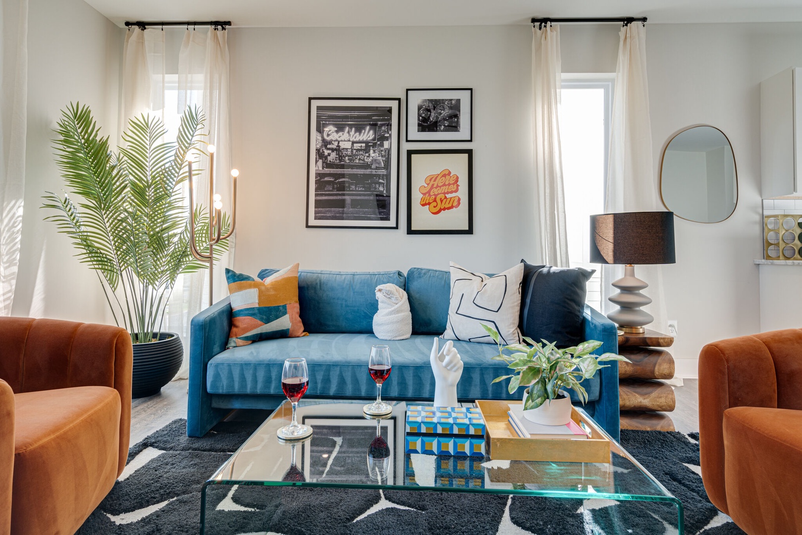 Bright and open living space draped in designer furnishings. Complete with sofa, smart TV, and 2nd floor balcony.