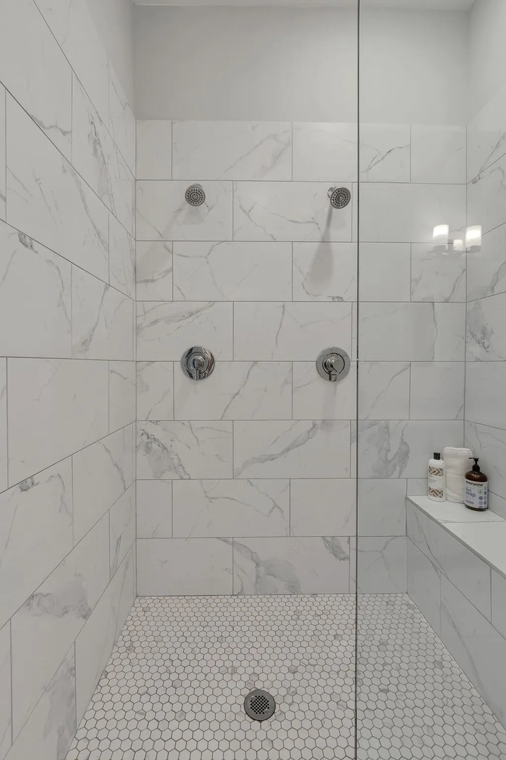 Primary bathroom with dual vanity walk in shower and master closet