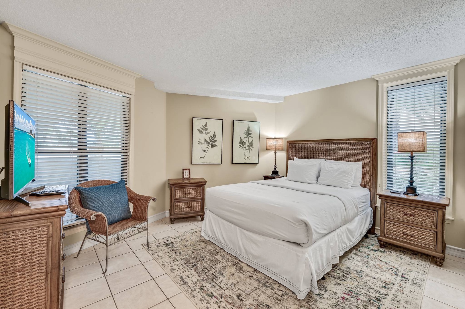 Guest bedroom with queen bed and TV
